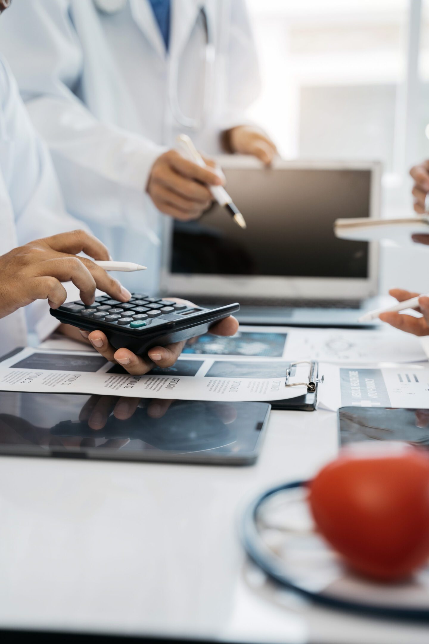 Doctors use a service fee calculator to save money on health insurance, drug cost concepts.